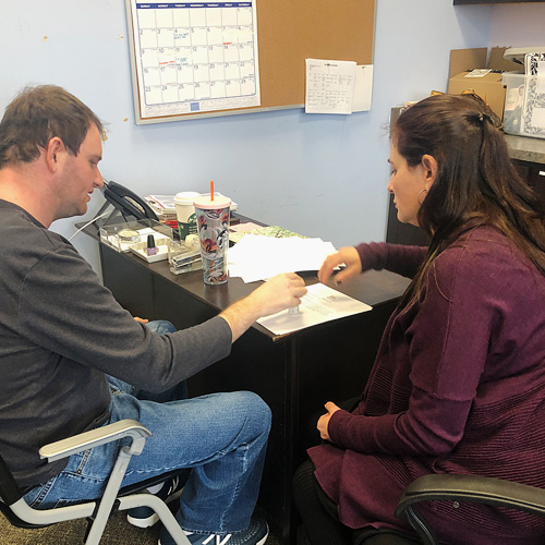 Jerry sitting in office at Adult Day Program working at a table